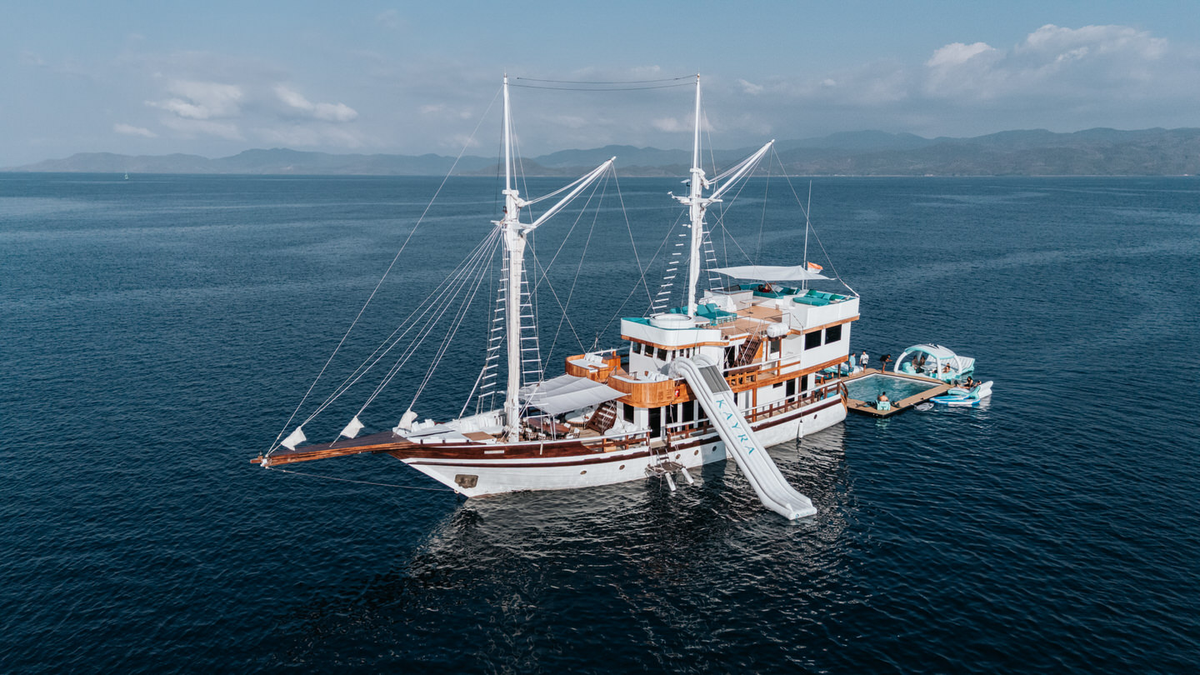 M/V KAYRA — traditional Indonesian Phinisi vessel at anchor, aerial view